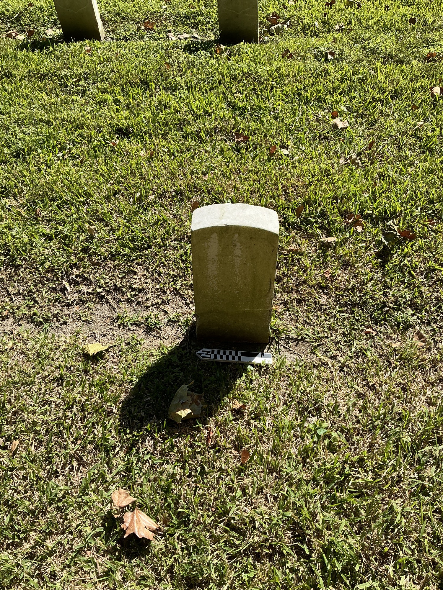 Extra image of historic upright marble headstone with recessed shield face.