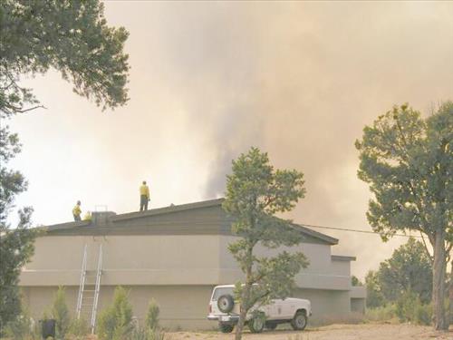 Burning and smoke in and around structures during the Long Mesa Fire, Mesa Verde National Park, July-August 2002
