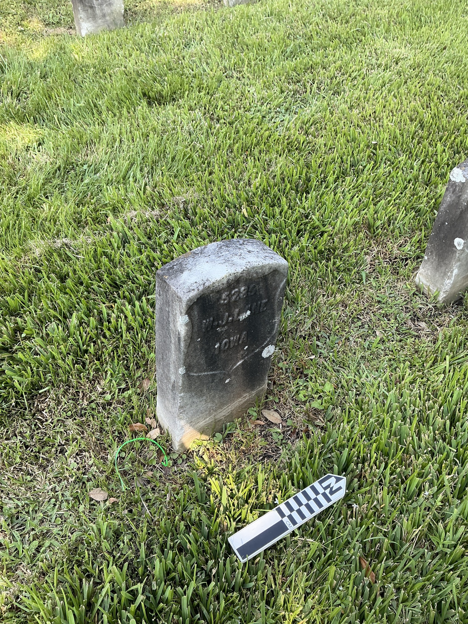 Extra image of historic upright marble headstone with recessed shield face.