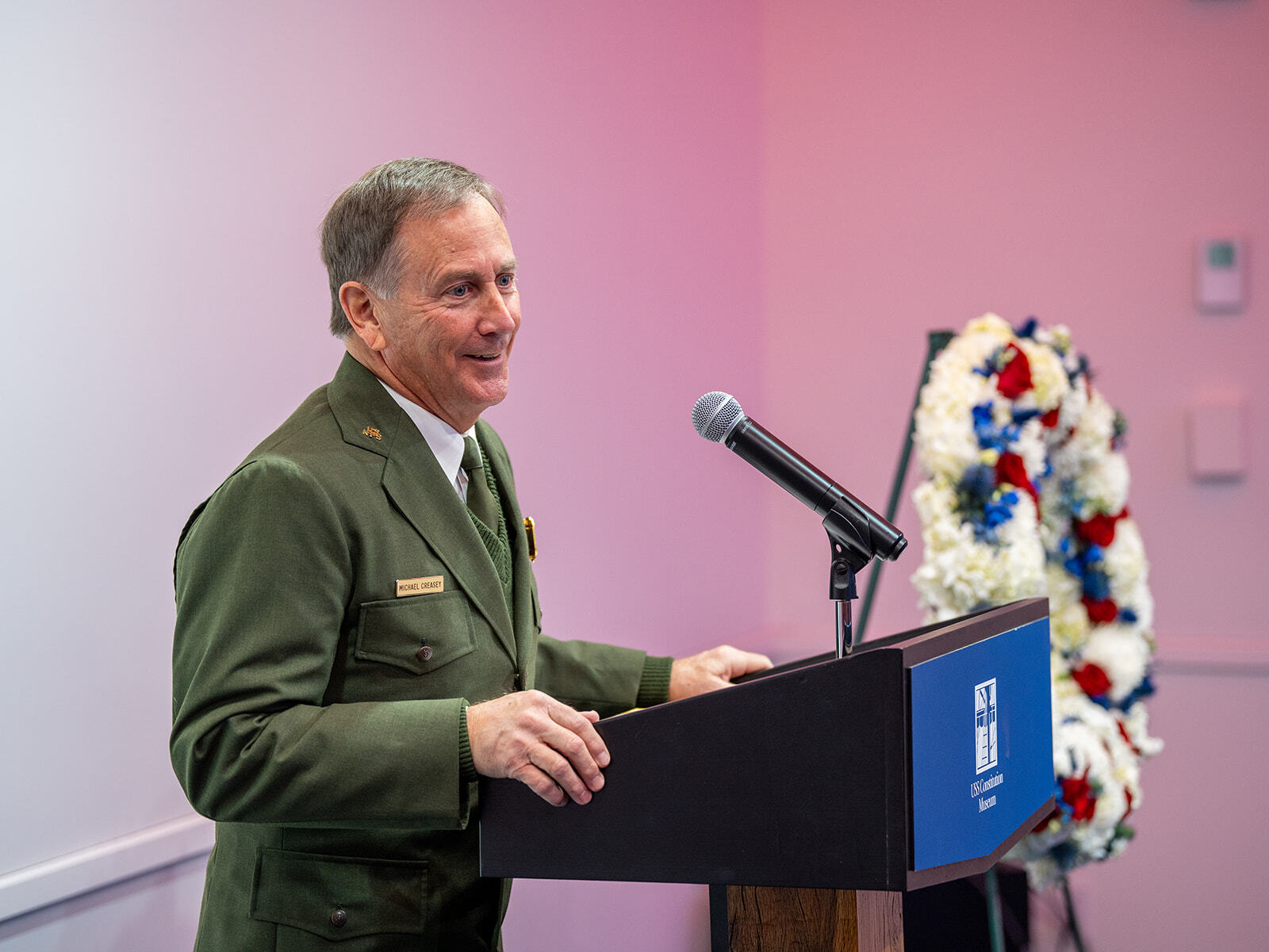 Man in NPS uniform giving remarks behind a podium.