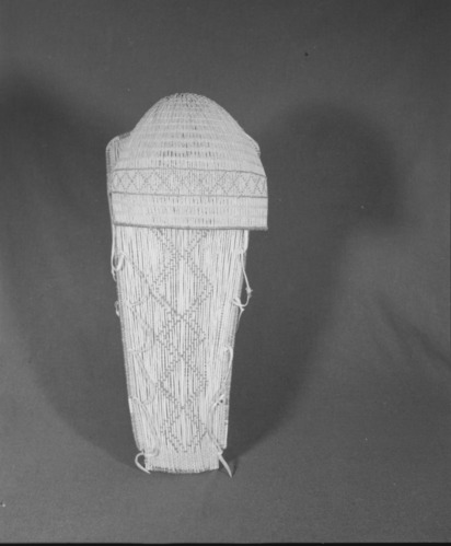 Marie Rozier Collection, Catalog No. 135. Object: Western Mono cradle basket. Dimensions: 11 x 26". Materials: Redbud, sourberry, sedgeroot, chaparral sticks, brain-tanned buckskin. Technology: Hood coated with soaproot. Collection History: Made by Anna Charlie of Dunlap, used by Mrs. Martin Lewis and purchased from her in 1967 by Marian Steinbach. (She is Dave Lewis' sister's daughter). Photographed by Michael Dixon in December 1982. Catalogued by Craig Bates and Barbara Beroza. Yosemite Collections, National Park Service.