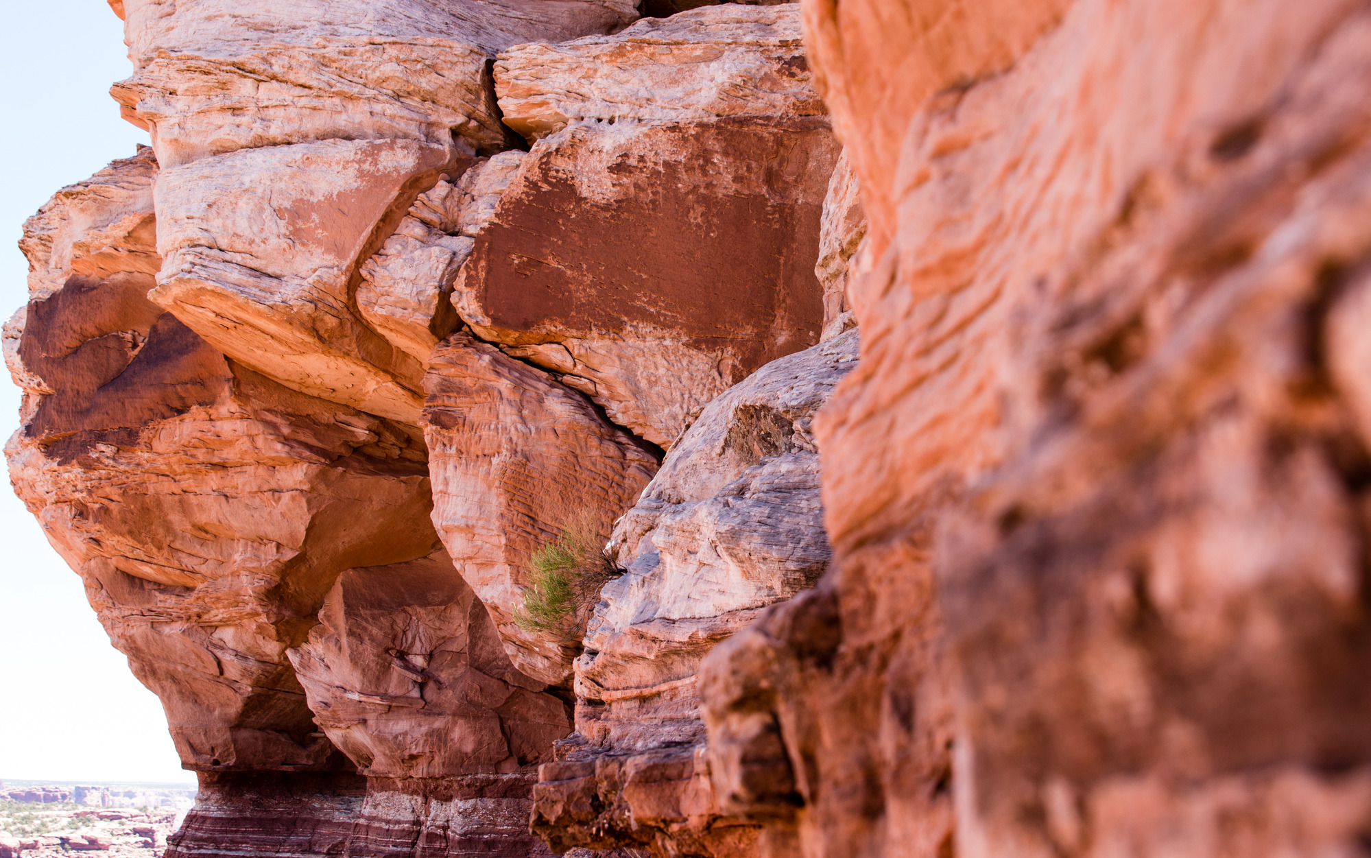 A close up view of some rocks on a cliff face in the desert. 