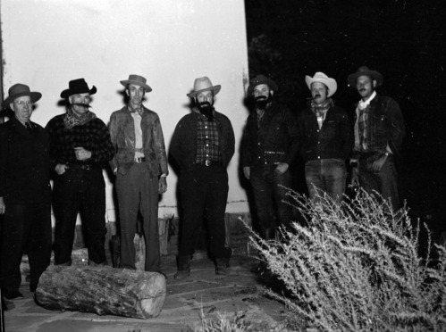 Staff in pioneer costumes and ranger in uniform posing on stage during campfire program. Campfire Day, September 19, 1957 at the South Campground amphitheater.