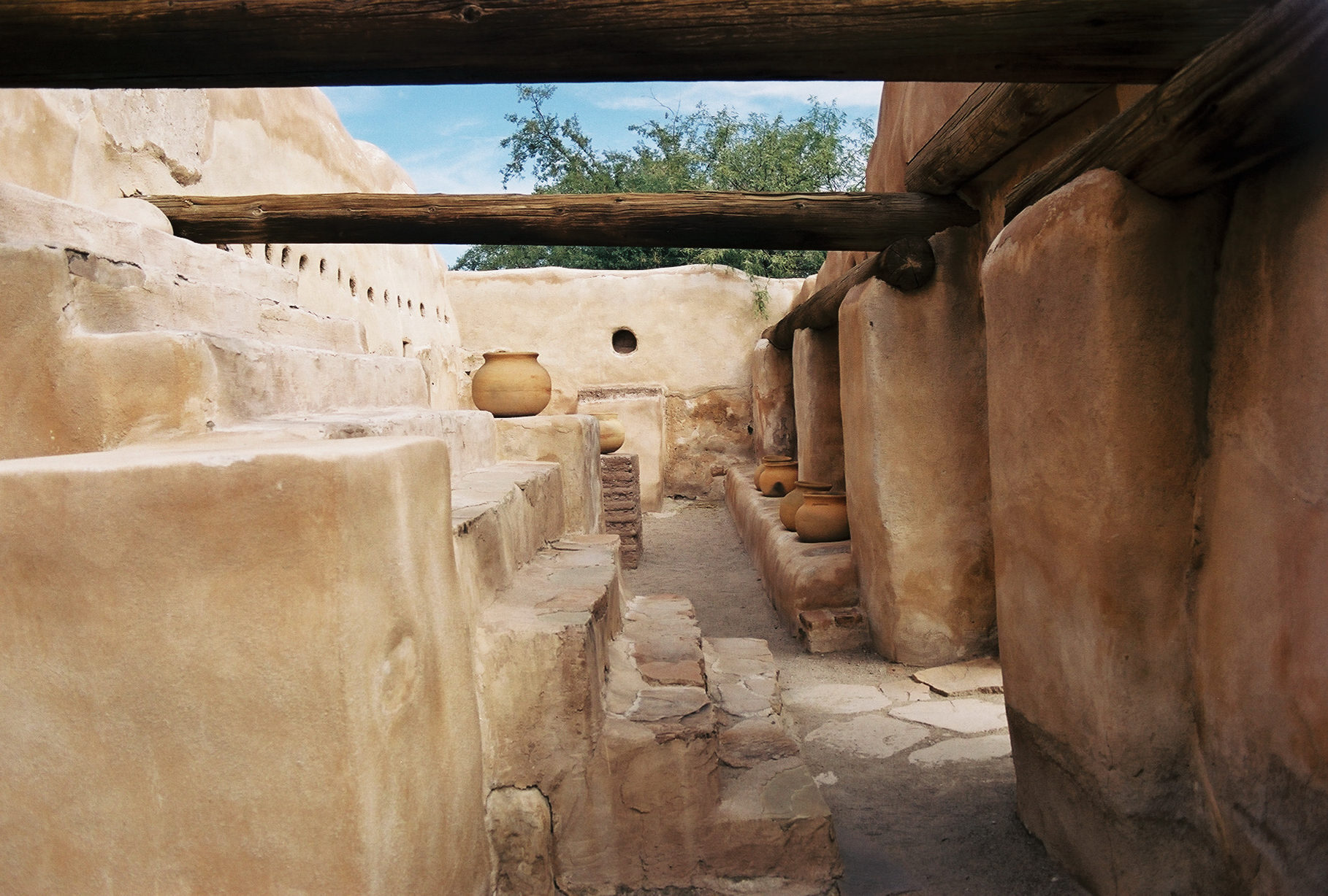 Mission storeroom from inside, with large steps and beam visible