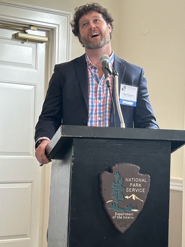 man talking at a podium with microphone