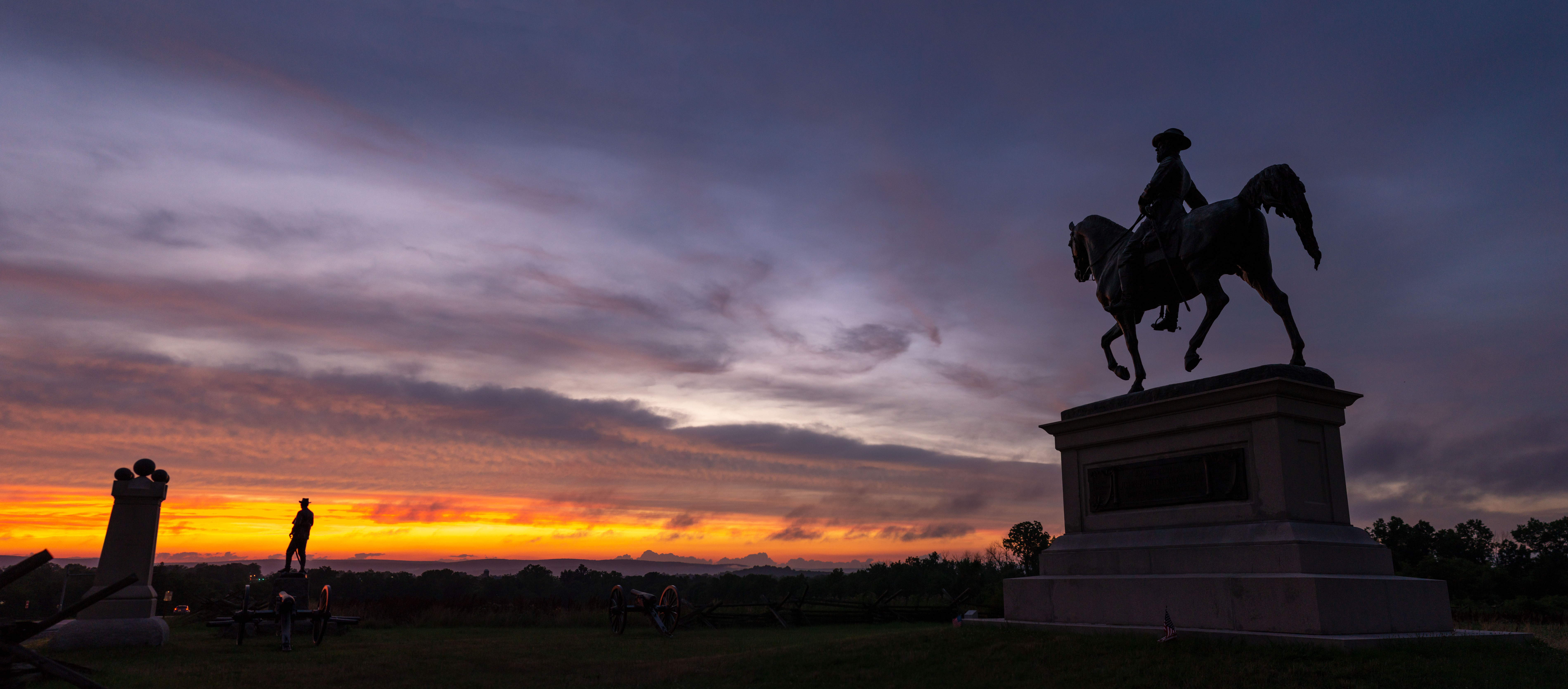 Civil War statues in silhouette.