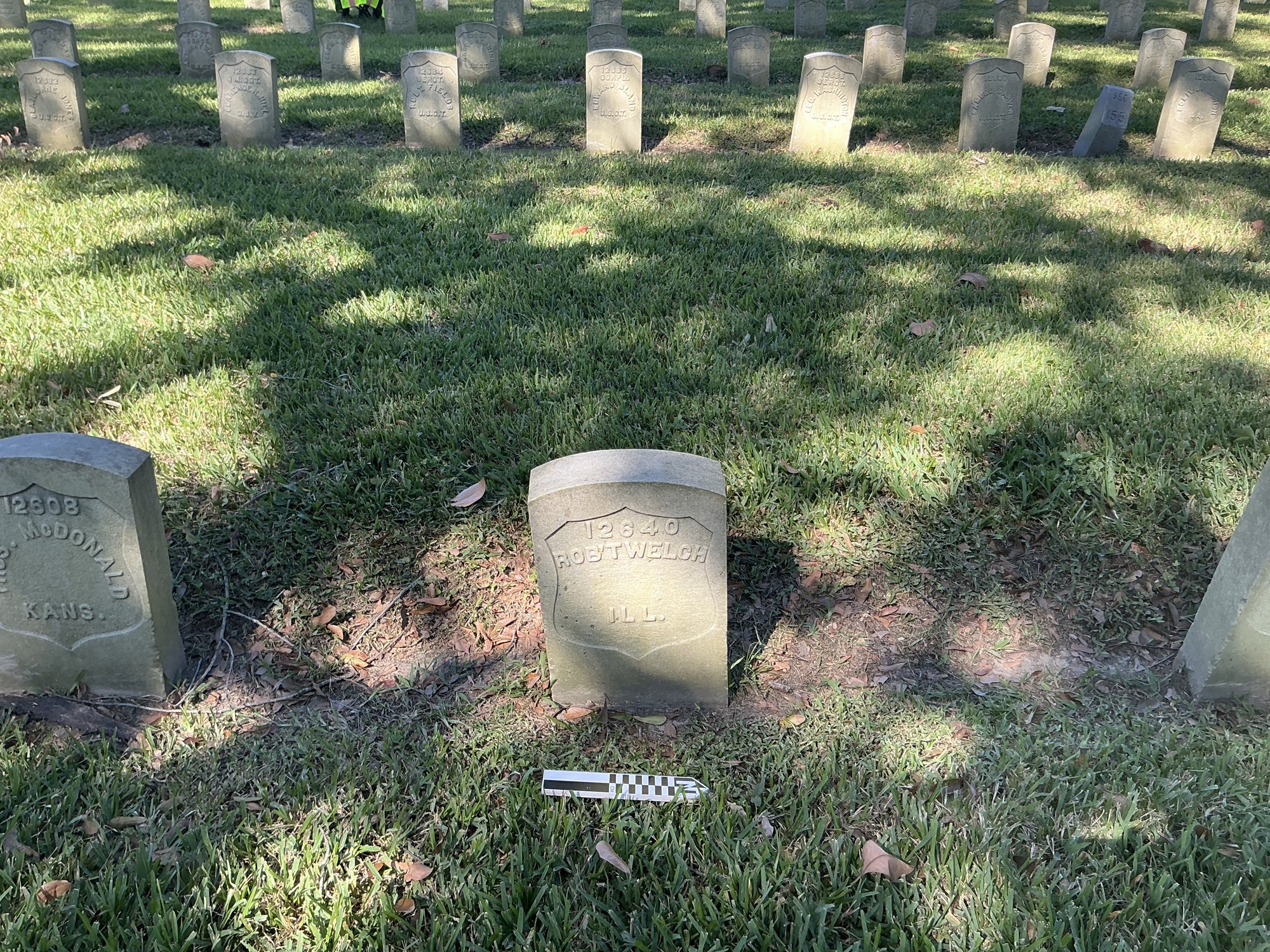 Extra image of historic upright marble headstone with recessed shield face.