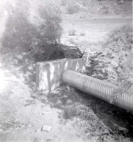 Park personnel installing a culvert/drainage pipe in location in Zion.