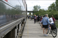 Cuyahoga Valley Scenic Railroad, Bikers Waiting to Board Train. In 2007 CVSR and NPS launched Bike Aboard!service to encourage use of the railroad as alternative transportation. For a $2 fare cyclists can ride the train in one direction and bike the other along the Ohio & Erie Canal Towpath Trail. Some images are at Rockside Station and others in Peninsula near the Peninsula Depot.
