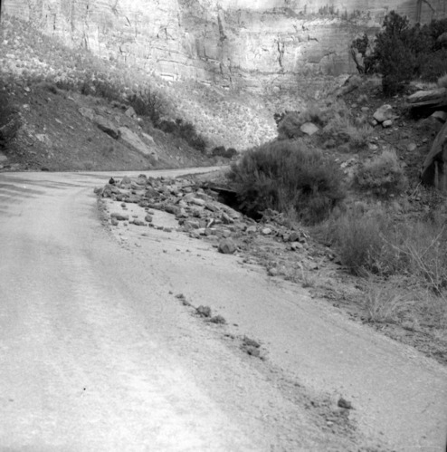 Flood damage on park road near utility area; cloudburst at 6:30 p.m. leading to 1.08-inches of rain. [One of two images on single film strip for ZION 8584]