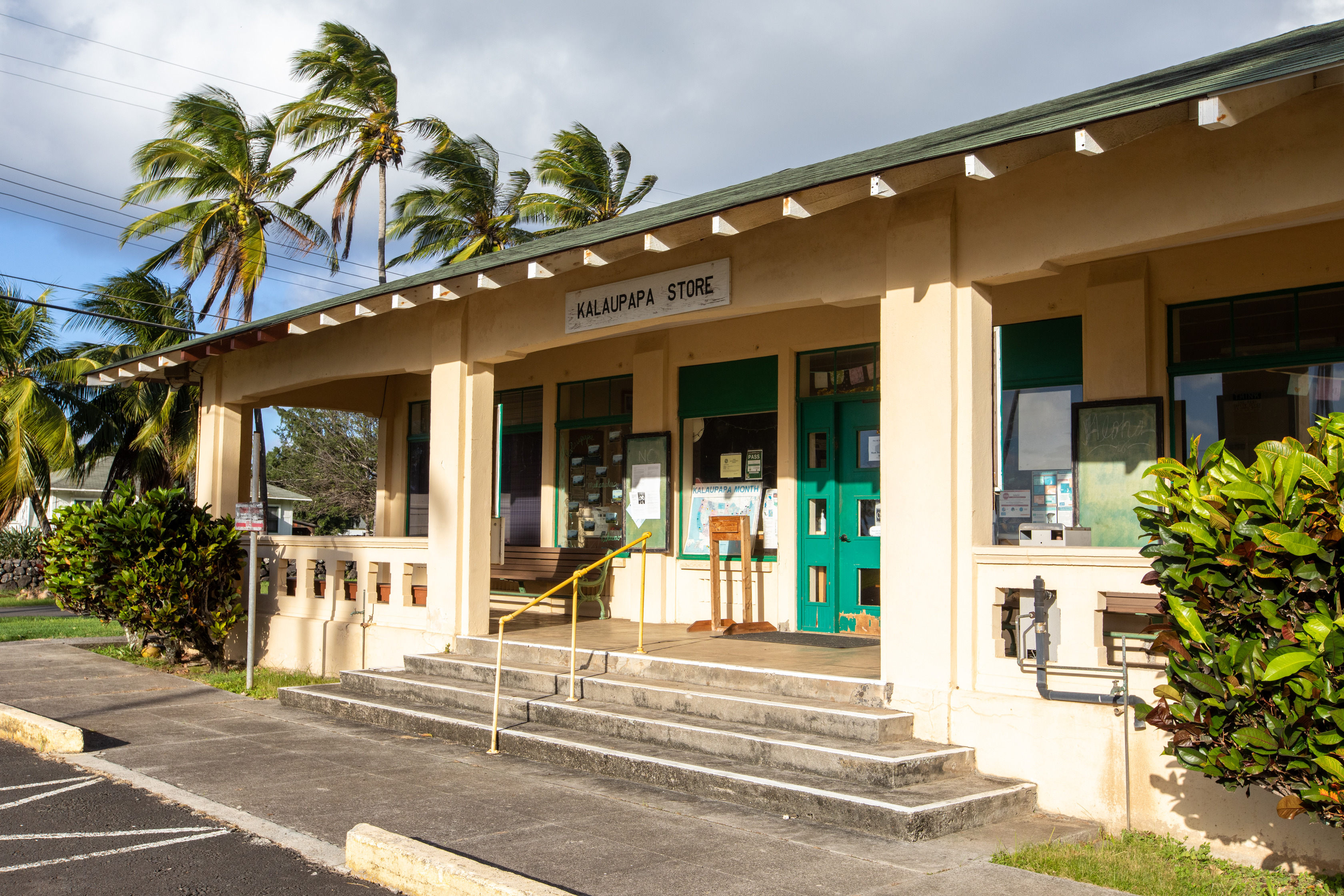 A tan building with a sign that reads Kalaupapa Store. 