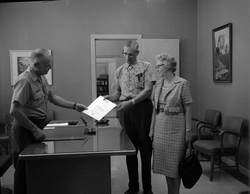 Superintendent Frank R. Oberhansley presenting certificate to Ernest and Stella Gisseman of Midvale, Utah, the Millionth Visitor to Zion National Park.