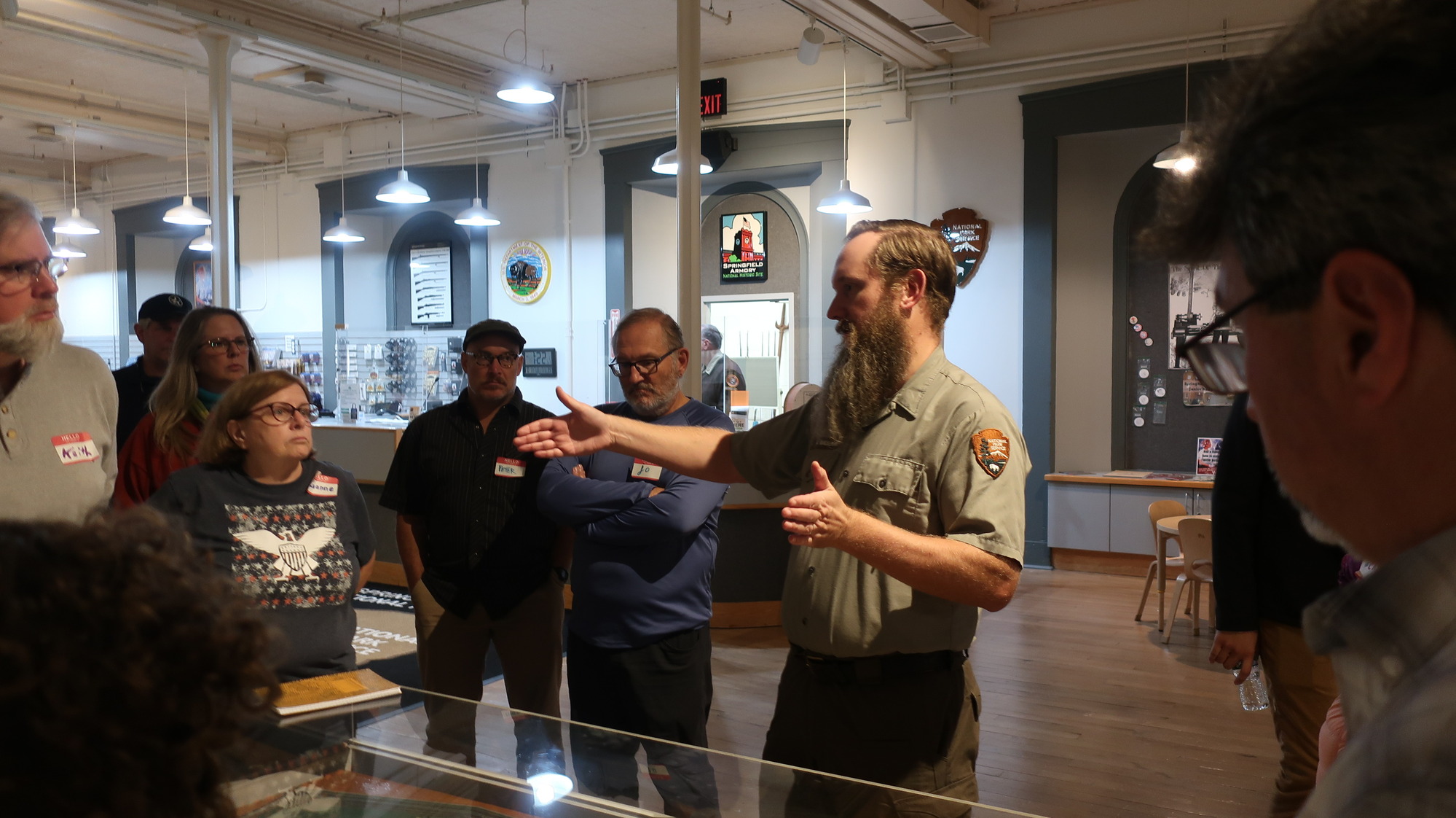 a group of people in a room watching a man speak.