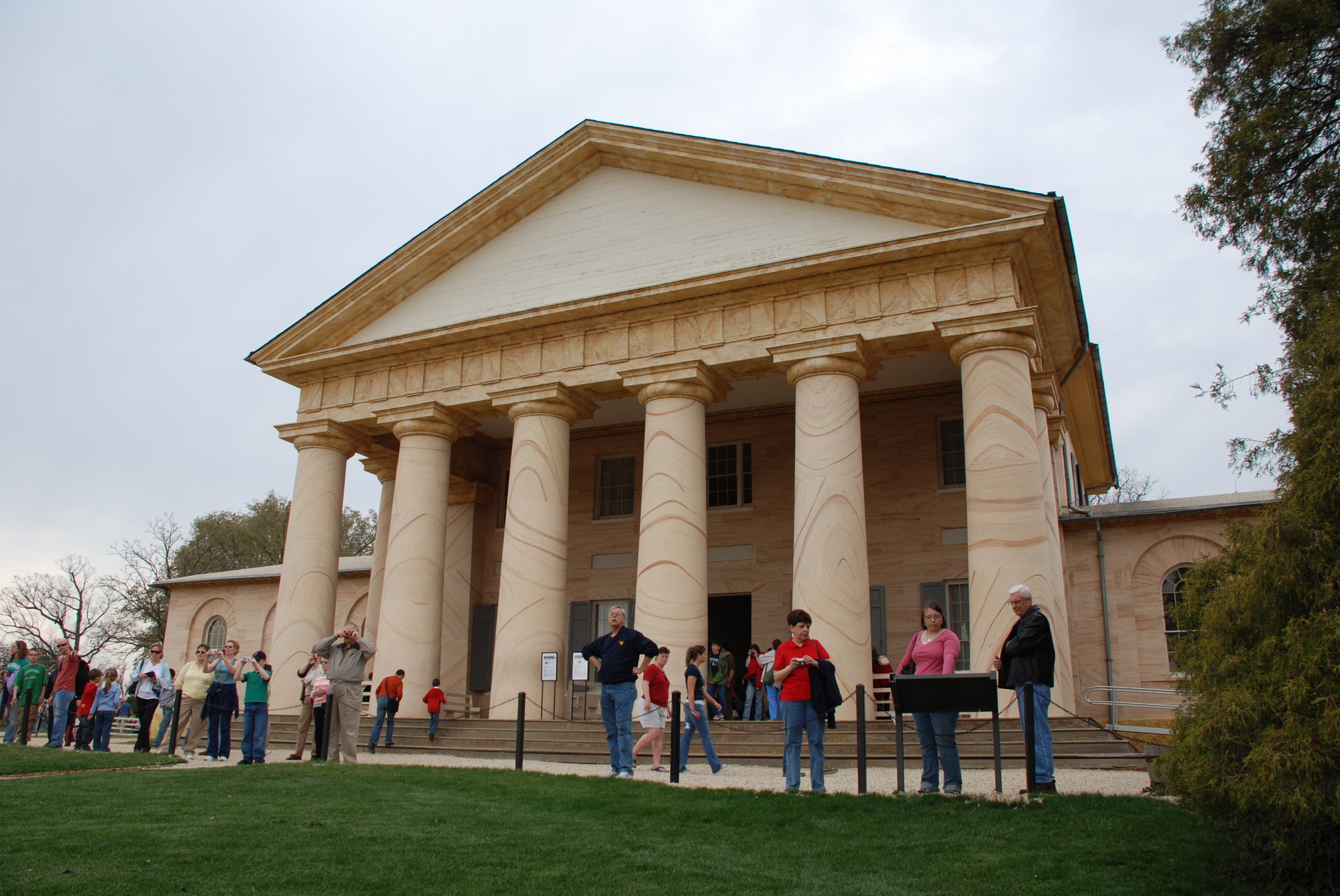 Several visitors stand outside of the Arlington House.