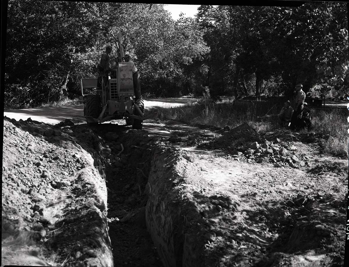 Sewer line construction, Watchman Residential Area- putting in temporary cesspool with new backhoe.