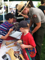 Ranger helping kids at a booth.