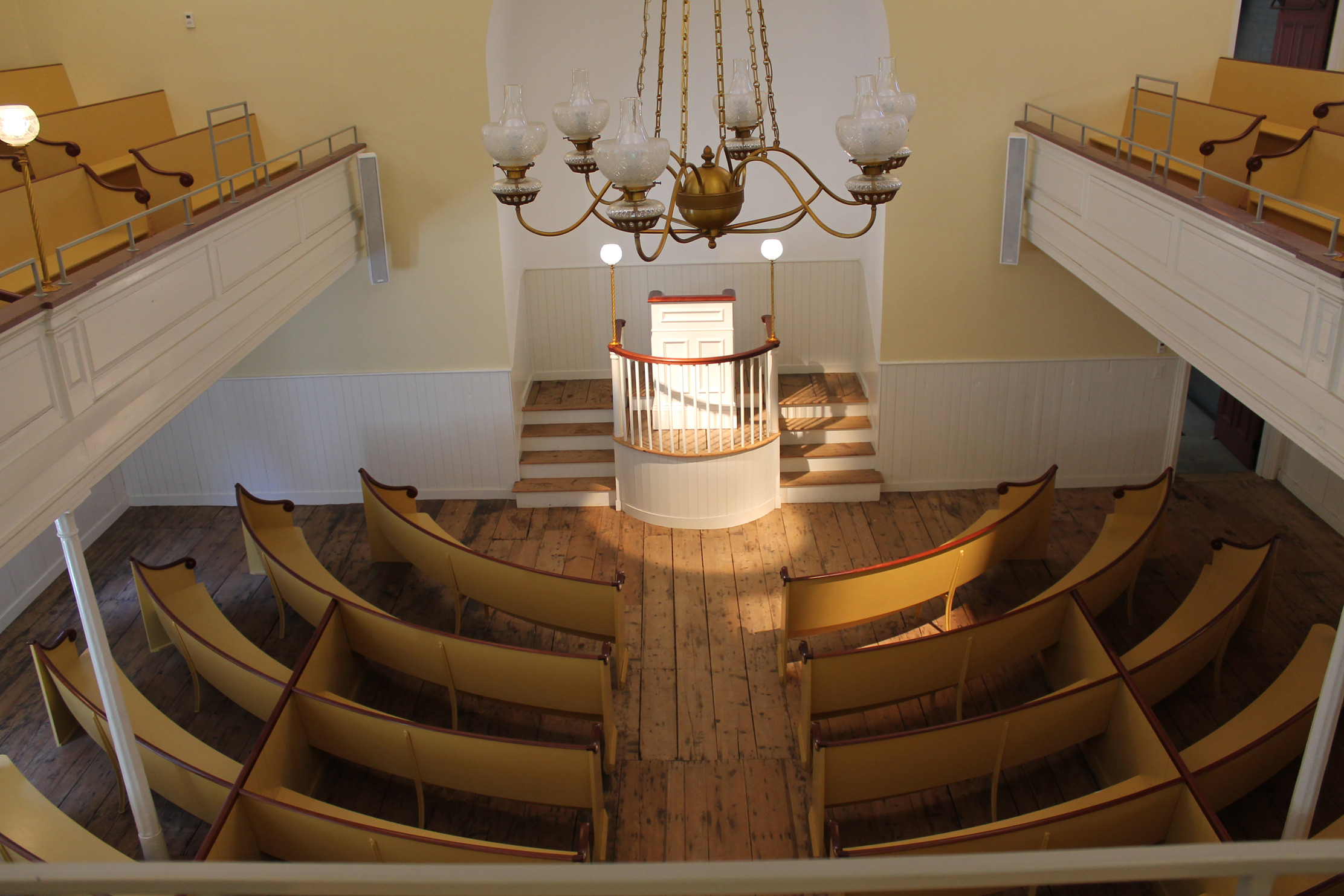 Birdseye view of pews facing an alter. 