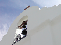 A white building with a bell on top.