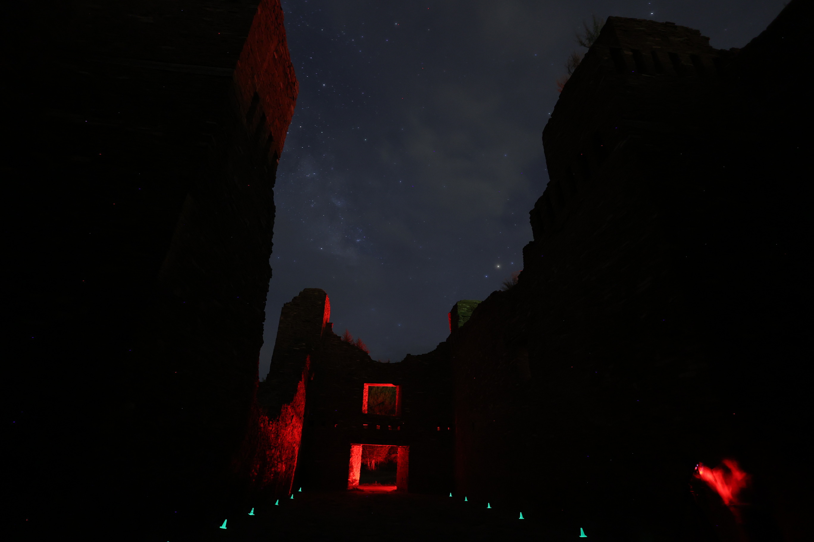 Dark sky photo with dark church remnants in the foreground.