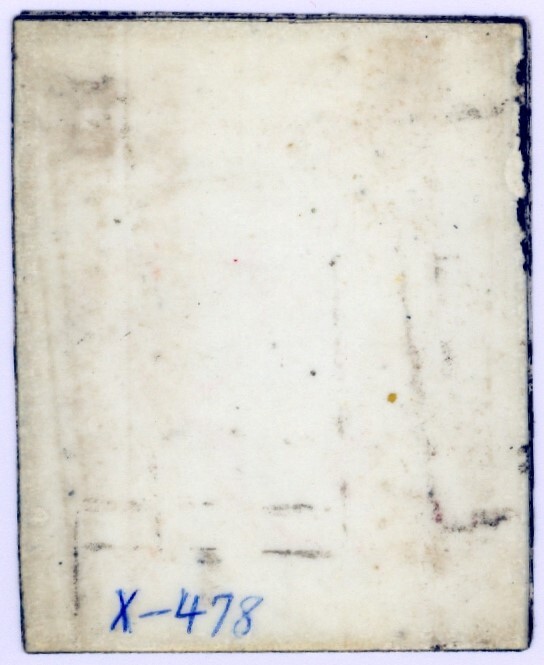 This is a scan of the back of a photograph depicting six soldiers posing for image in military uniform, gear, and holding weapons. The back has no markings.