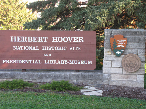 A stone and wood sign marks the entrance to Herbert Hoover park and museum.