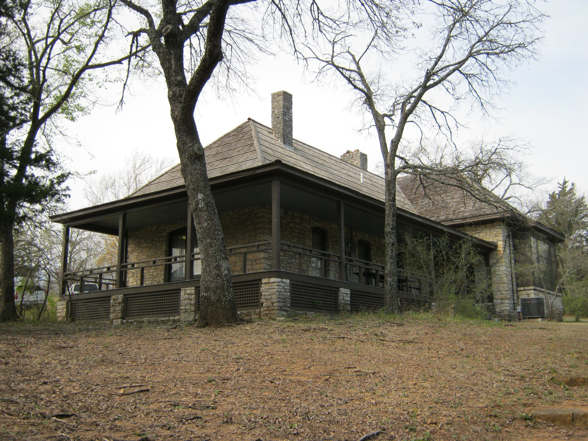 Maintenance building at Platt Historic District; stone structure with a wraparound porch.