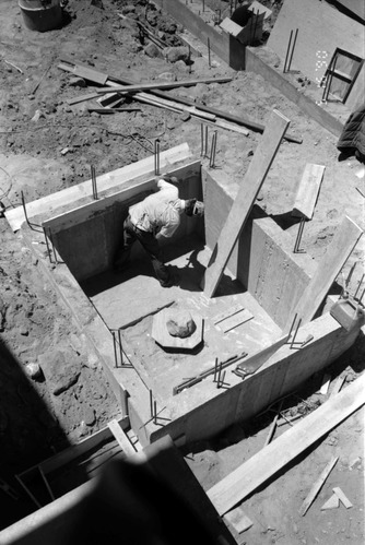 Man working on wall during the construction of headquarters addition.