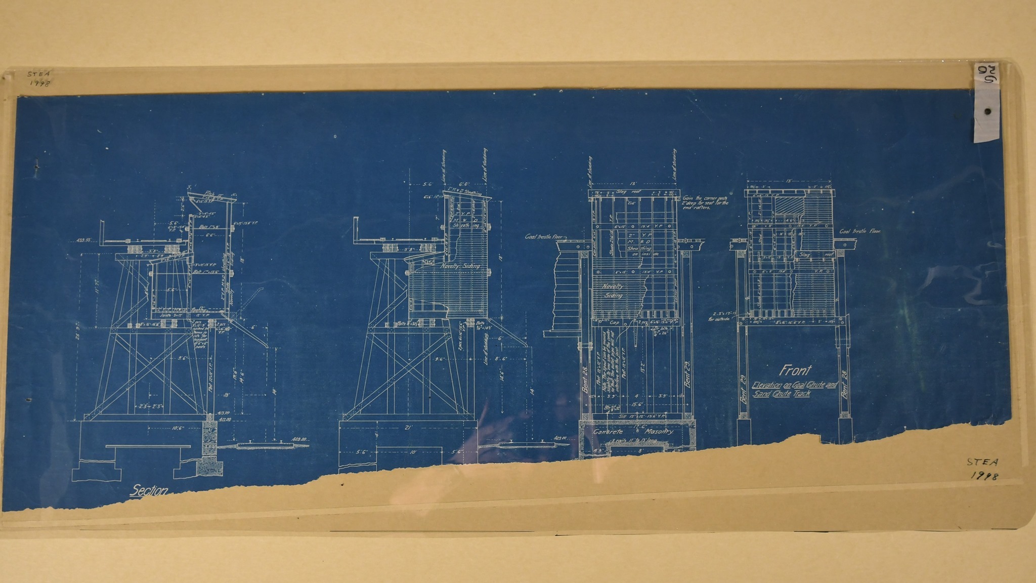 Blueprint diagrams of coaling dock/trestle, DL&W Railroad yard, Scranton, 1900-1906. "Elevation on Coal Chute and/Sand Chute Track." 4 views, front & side elevations, showing construction details, specifications of shed and spout near east end of structure. "s/26" on attached linen tape.