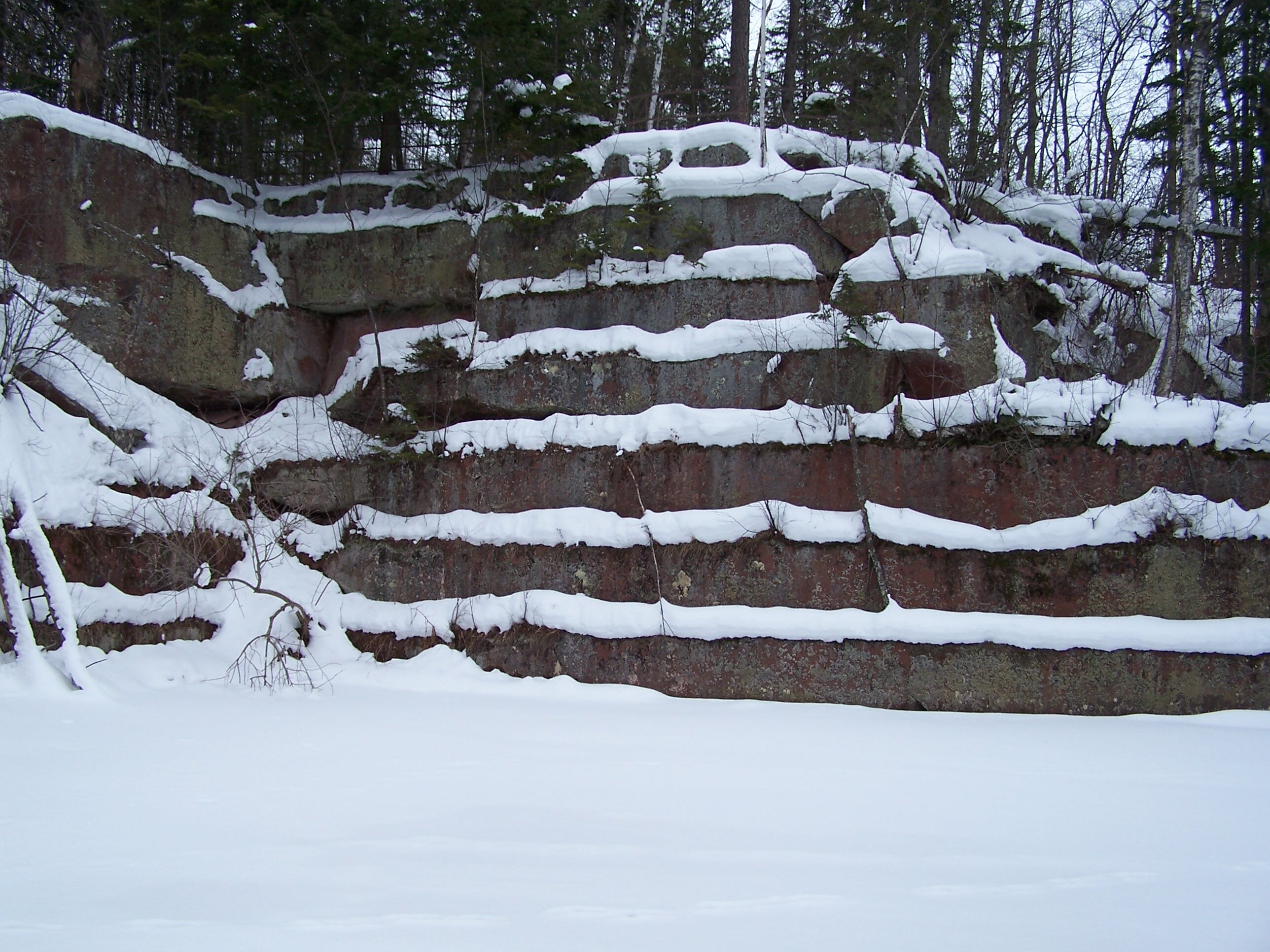 Snow on sandstone layers left in a quarry.
