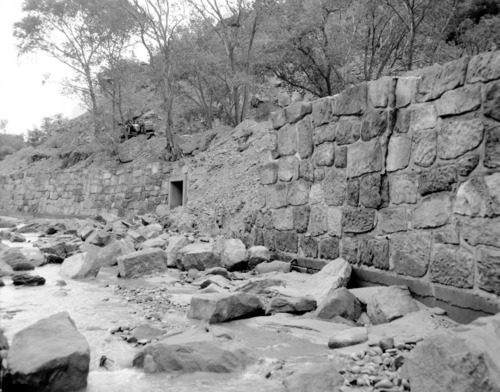 Flood damage to rock wall on Virgin River, a quarter mile south of Court of Patriarchs. Record of damage or defective workmanship.