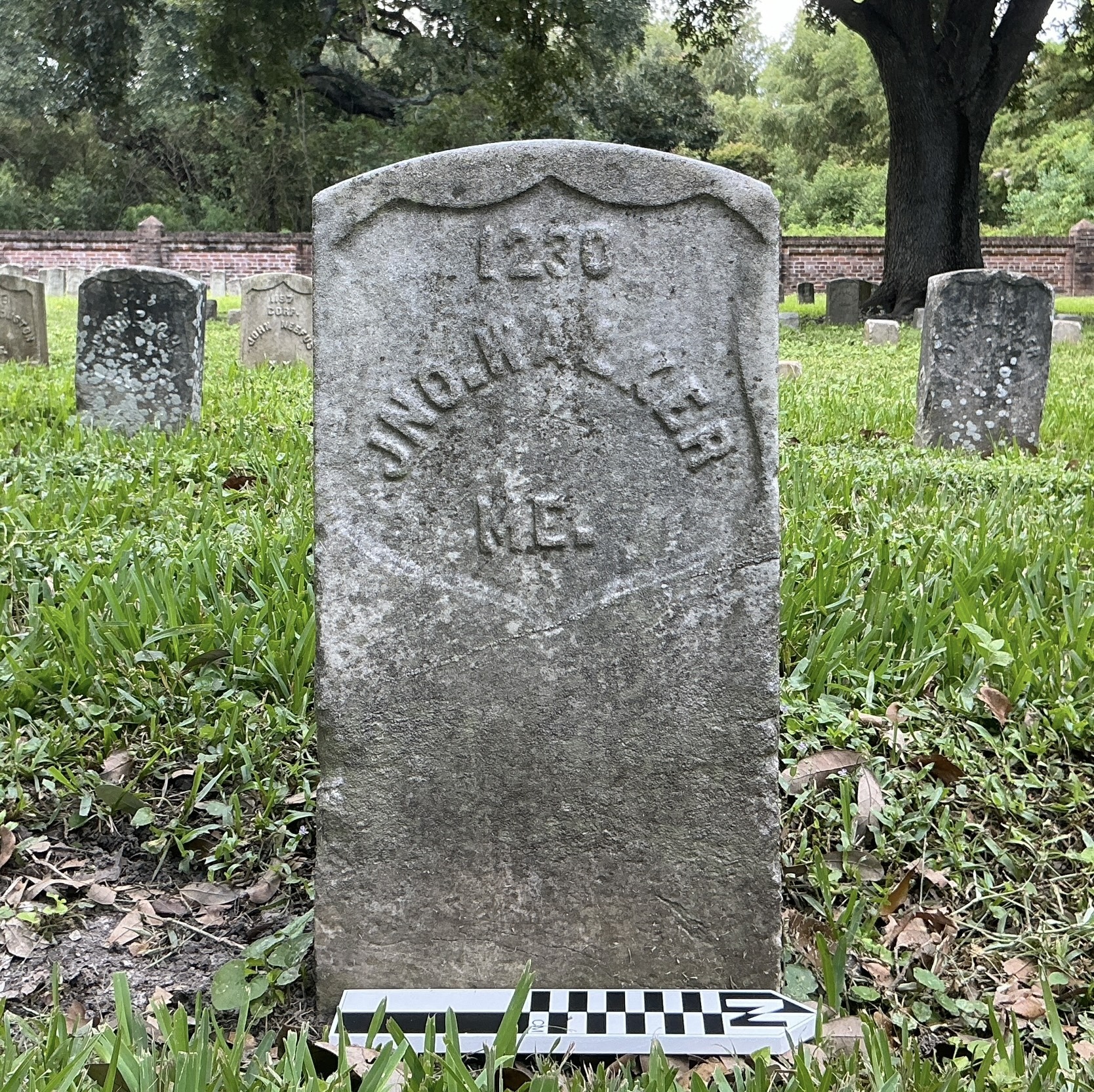 Extra image of historic upright marble headstone with recessed shield face.
