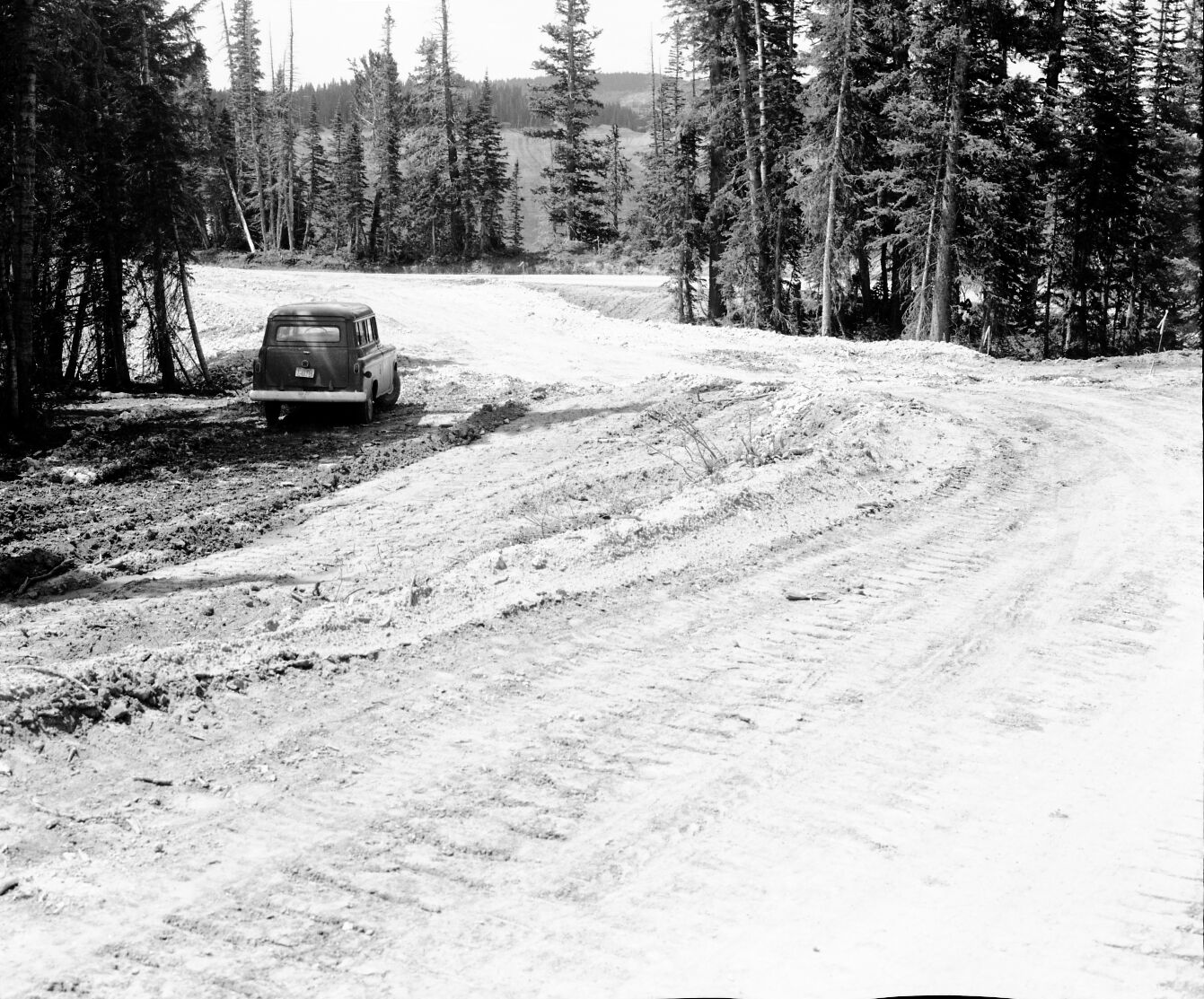 Car parked next to large, leveling fill at foot of Dugway Hill, about a third of the way done.