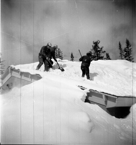 BW Photos showing rangers digging out the visitor center from snowdrift.