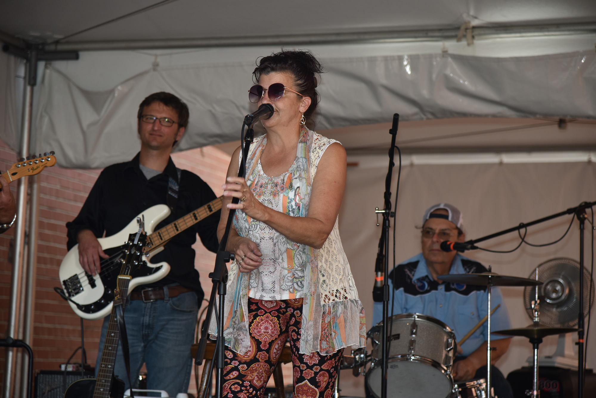 A female singer behind the microphone on a stage