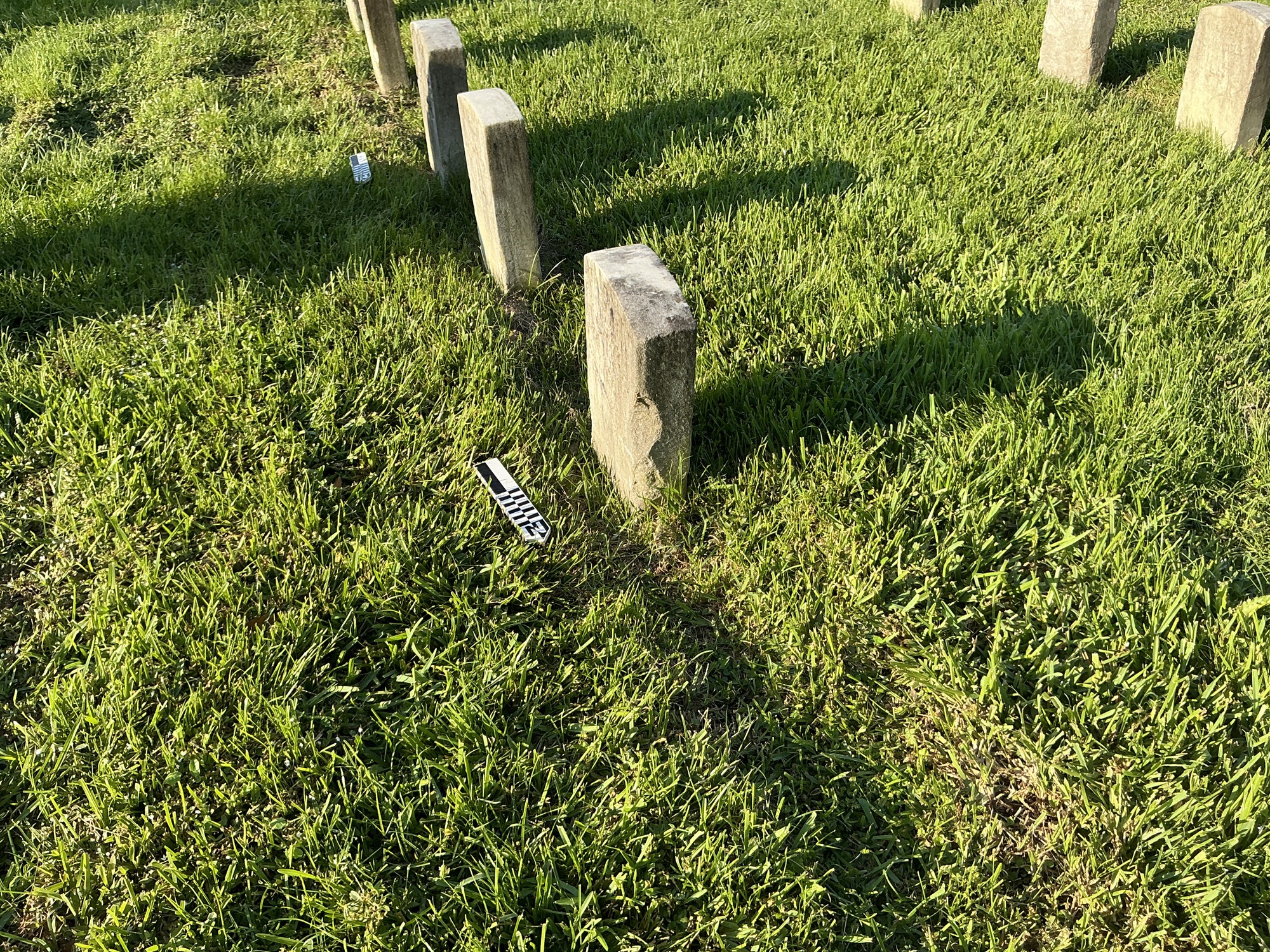 Extra image of historic upright marble headstone with recessed shield face.