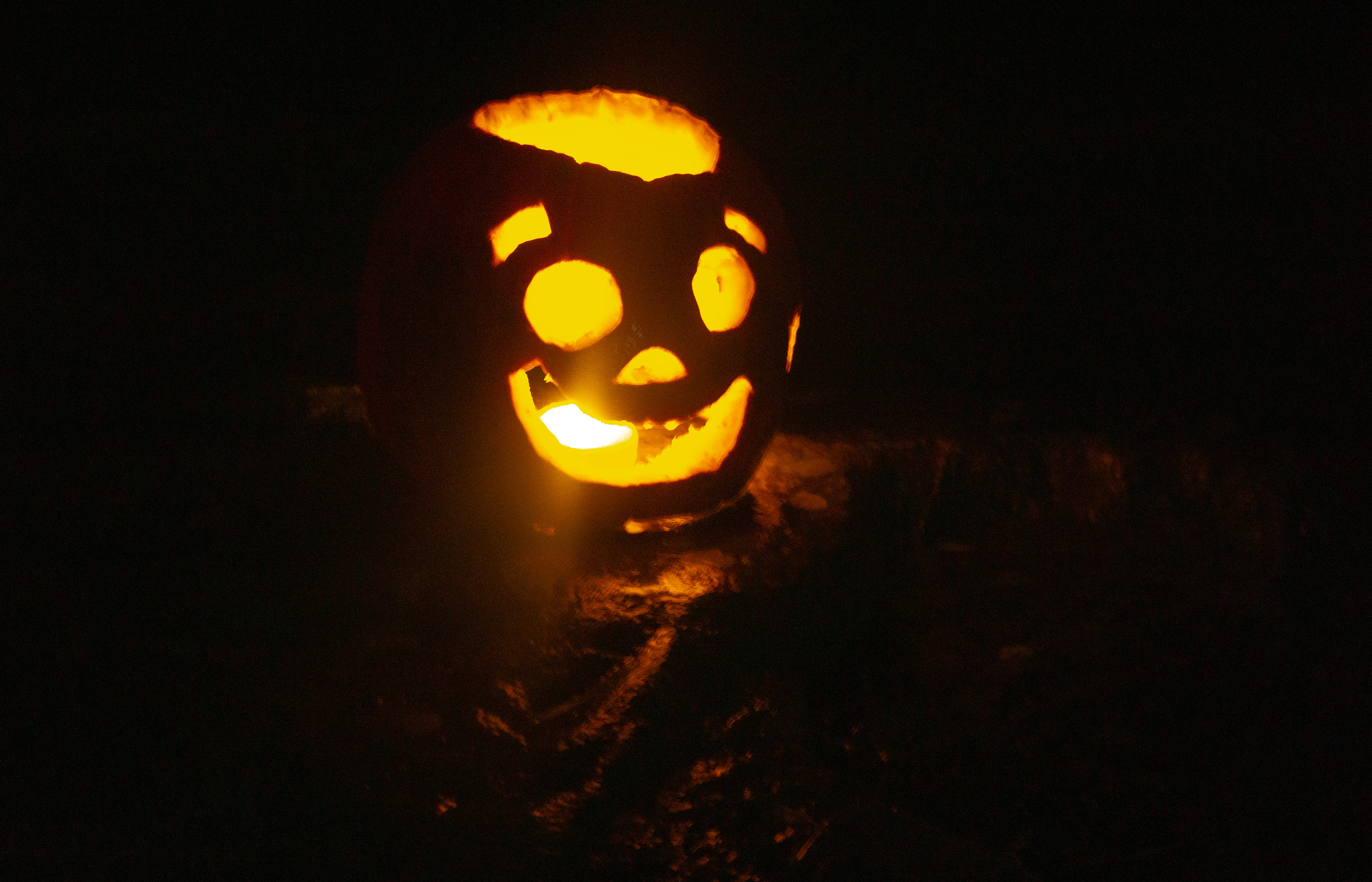 Happy looking carved pumpkin lit from within