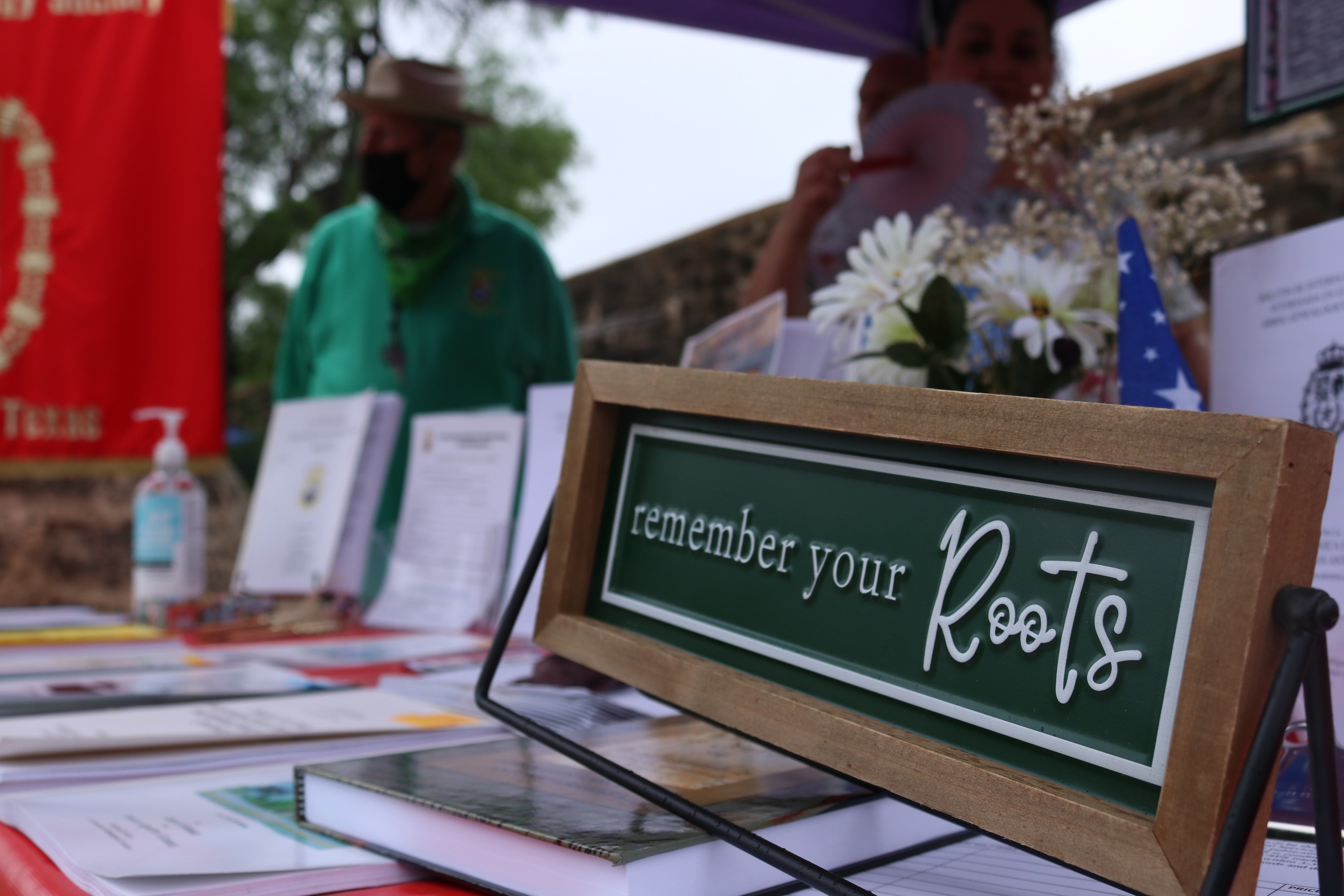 Sign on a table that says "remember your roots". 