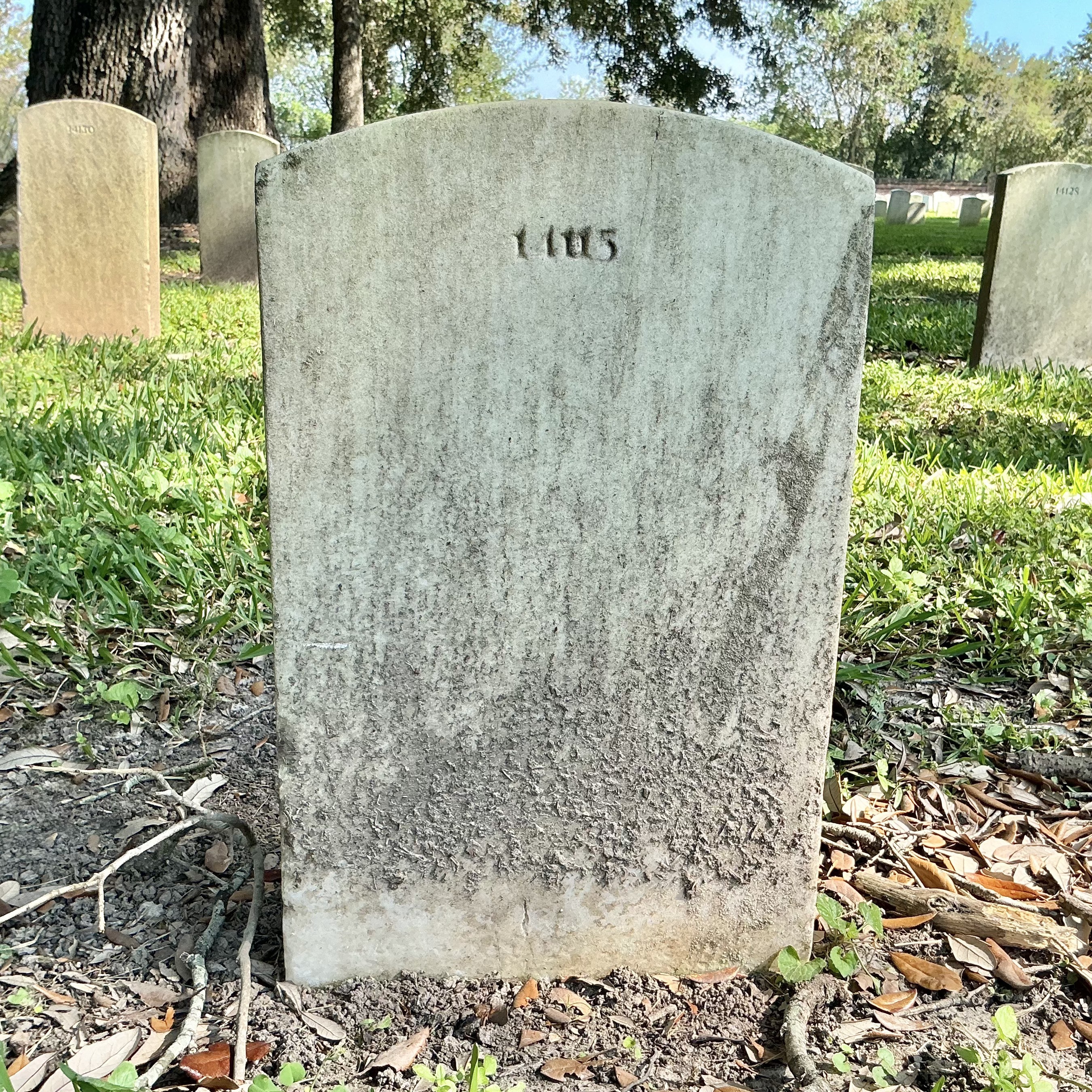 Back of upright marble headstone with flat face.