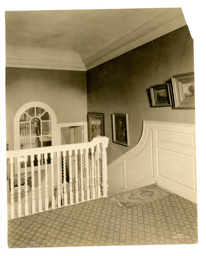 Black and white photograph from top of staircase.