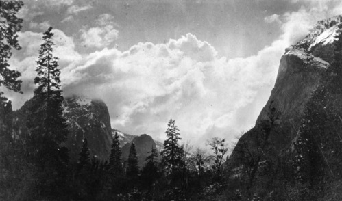 Copied by DC in 1935. Original taken by George Fiske. Clouds over Cathedral Rock. An interesting story is that Mr. Fiske was thrilled upon developing this negative to find the familiar face of a San Francisco friend outlined on the cloud in the center. "Why that is _________" he exclaimed. A few days later, he learned that his friend died the same afternoon the photgraph was taken, and Mr. Fiske always considered this a spirit photo.
