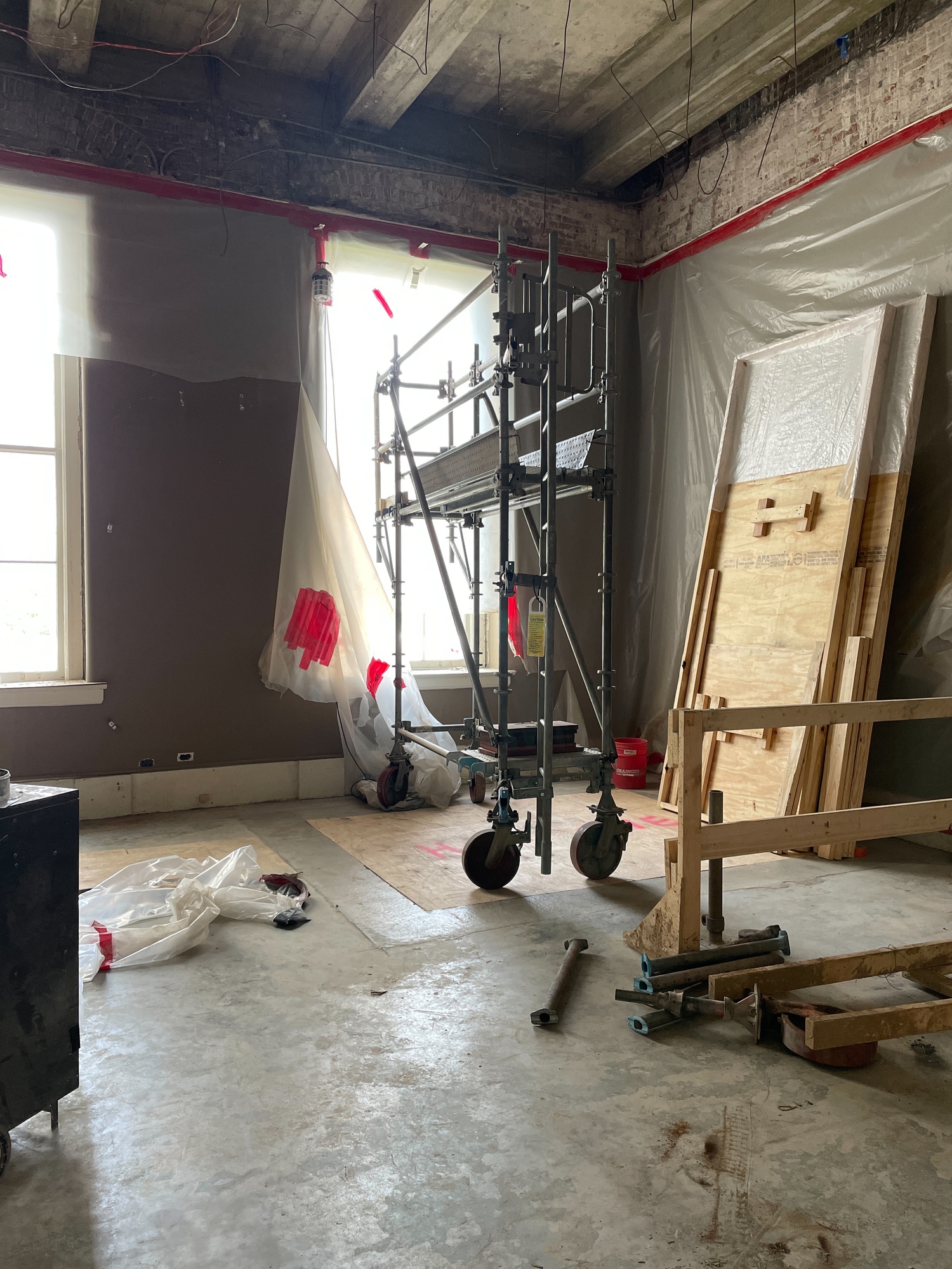 A folded scaffold sits in the room that will be converted into accessible restrooms and the new elevator.