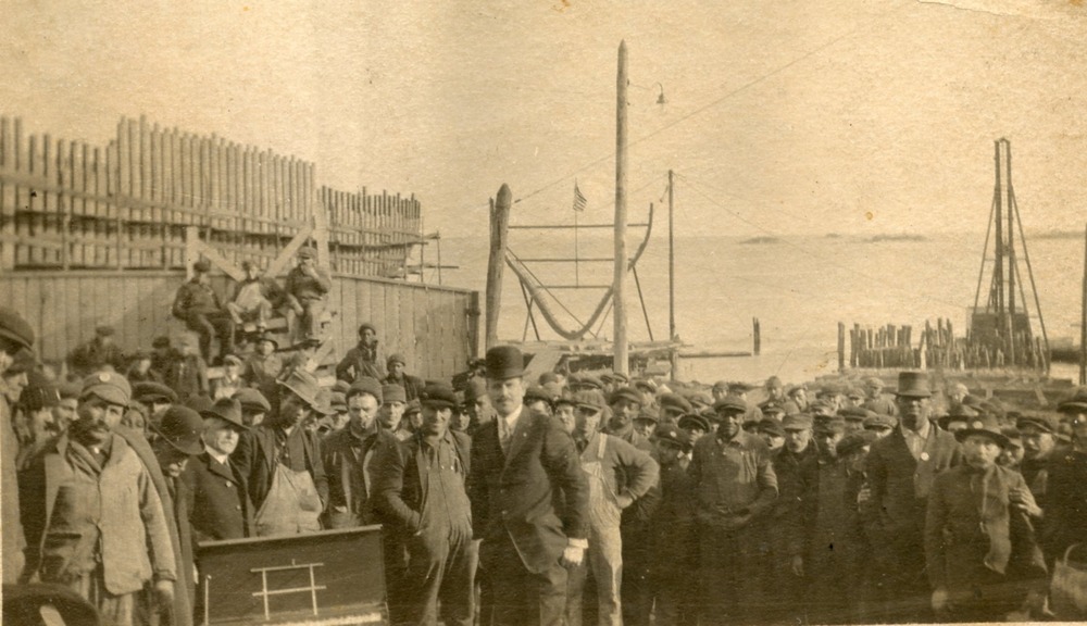 Shipbuilders standing as a group at the Noank Shipyard.