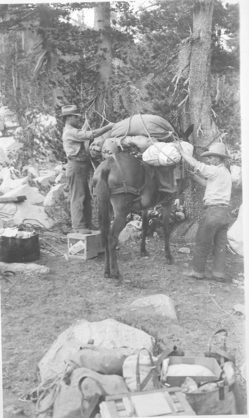 Two men packing horse for Field School
