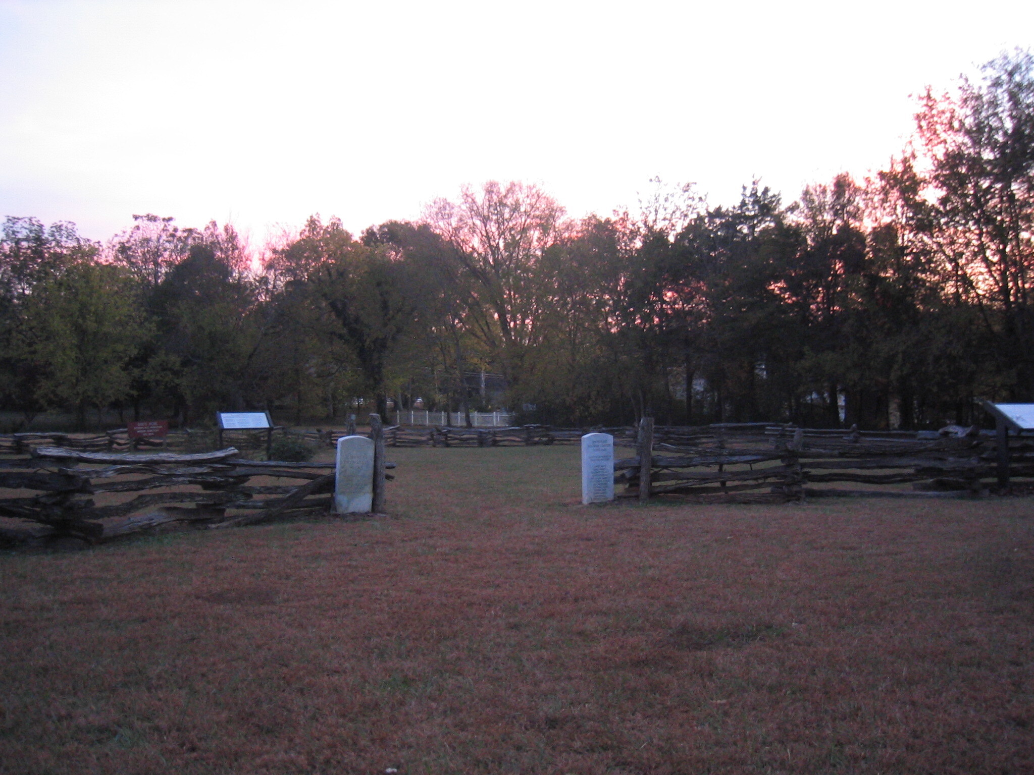 A wooden fence in the middle of a field.