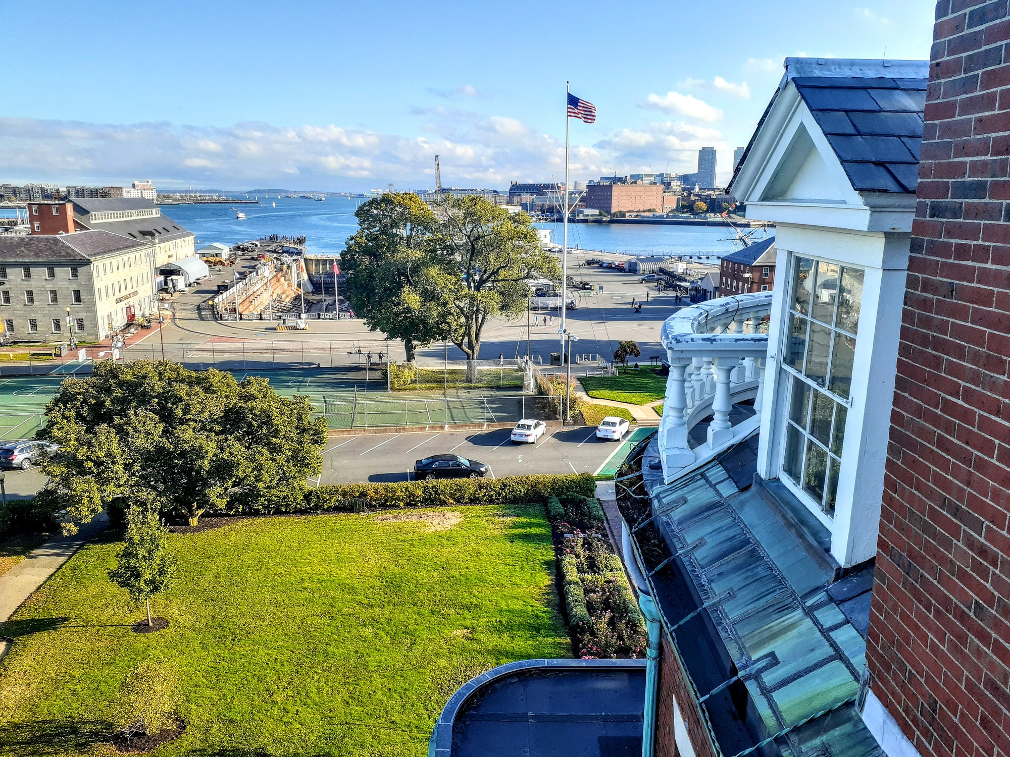 View of the Charlestown Navy Yard from a building with the building along the right side of the photo and the view of the Yard to the left. 