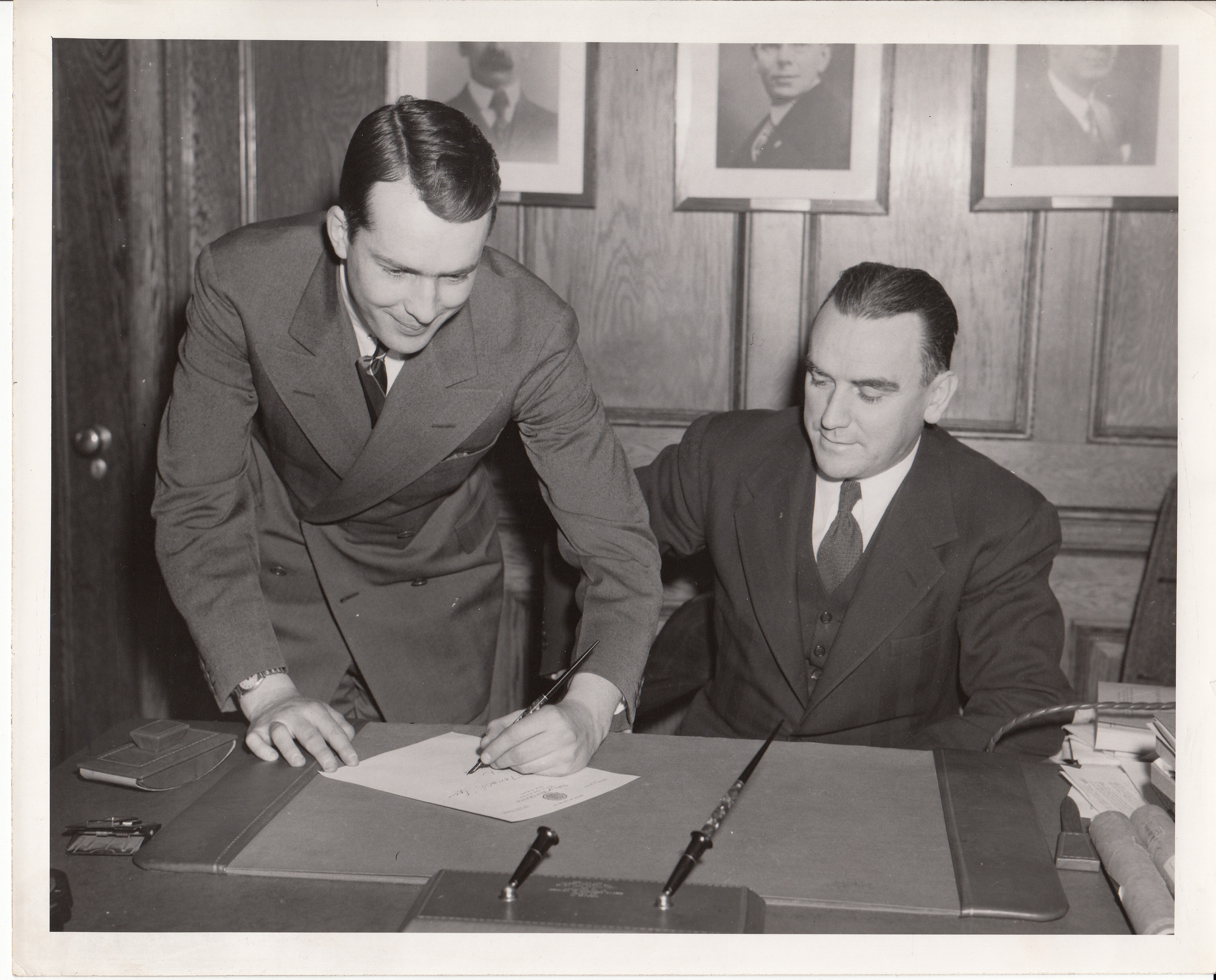 Thomas Edison Sloane signing petition requesting that the premiere of "Edison, the Man" be in The Oranges, Mayor Bernard Degnan at his side.