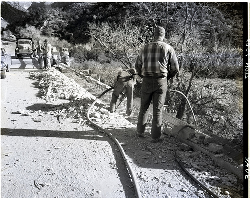 Removing old bridge curb by cutting and blasting.