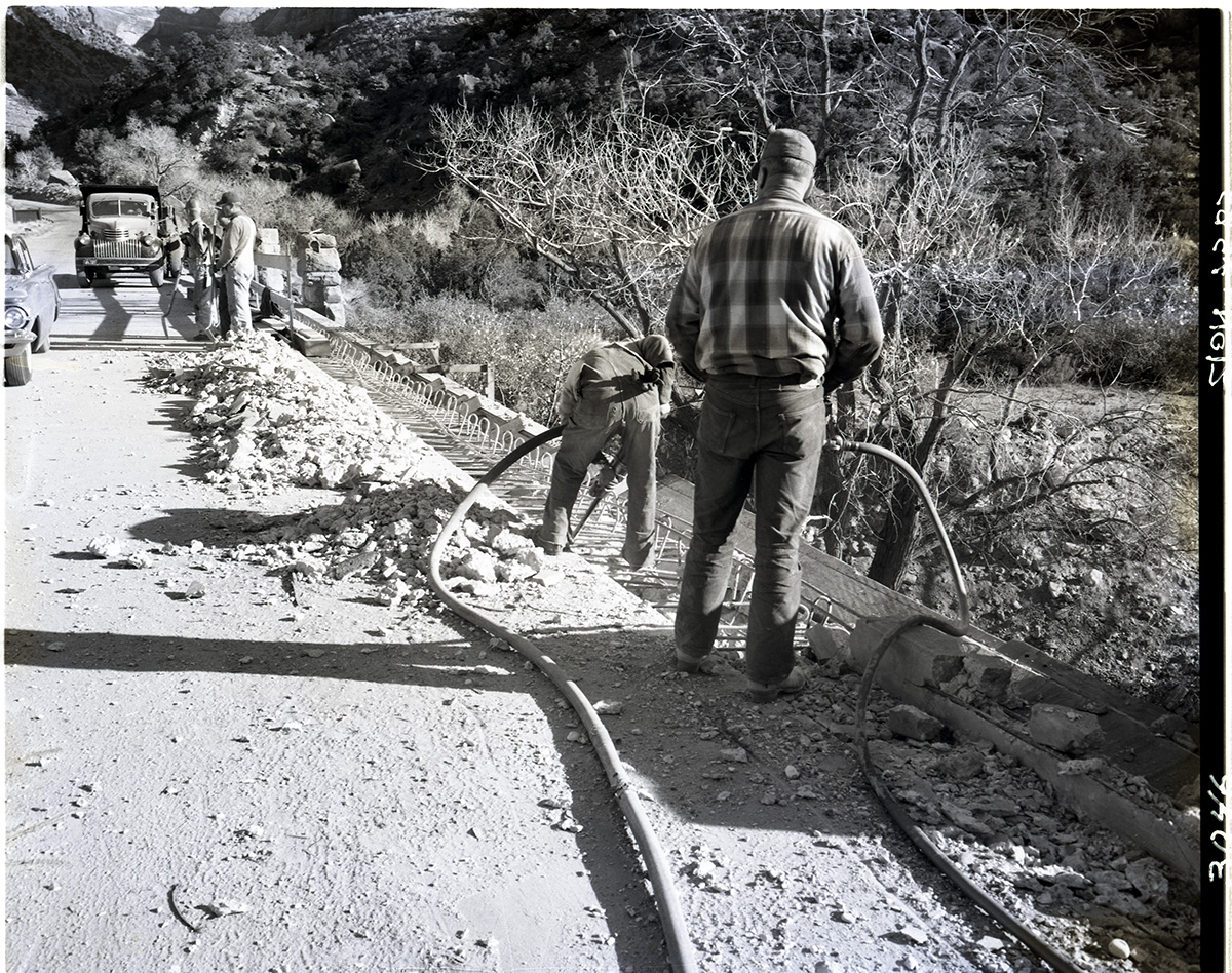 Removing old bridge curb by cutting and blasting.