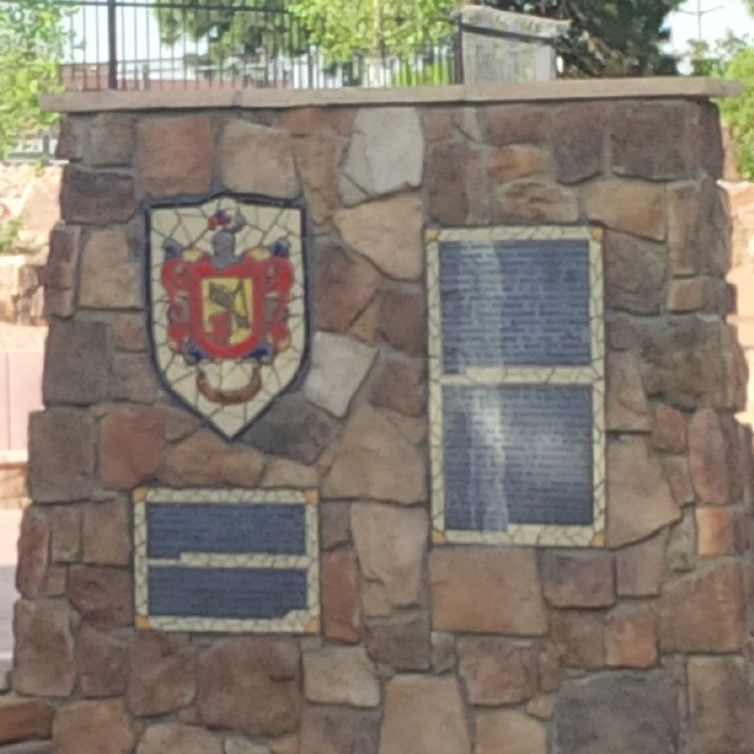 A stone monument with plaques on it.