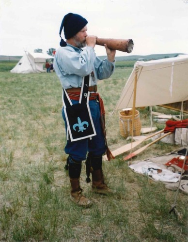 man in historic dress with horn
